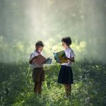 children reading outdoors